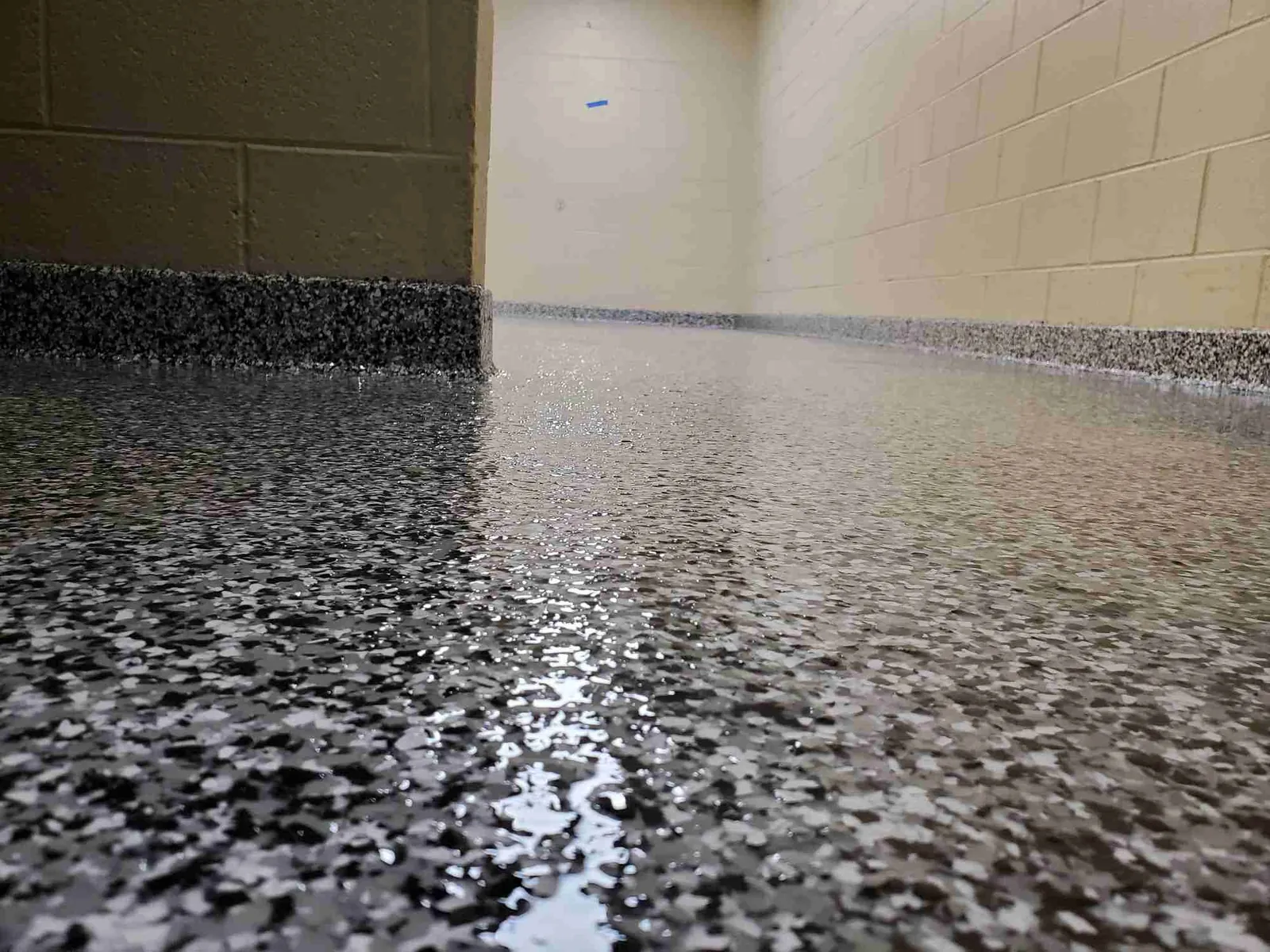 Garage floor with interlocking tiles and rubber mats as anti-slip alternatives